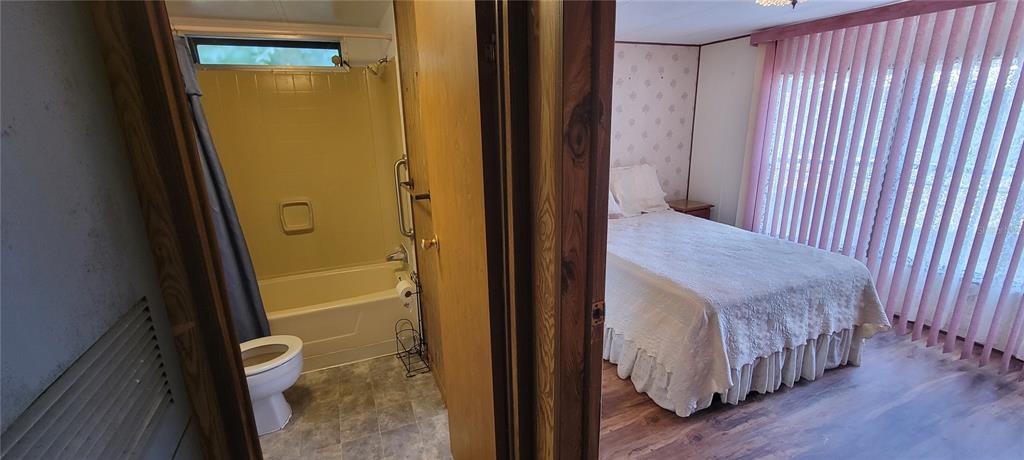 100 Pine Drive Kenansville, FL 34739 - Photo 16 of 34 a view of a hallway with wooden floor and staircase