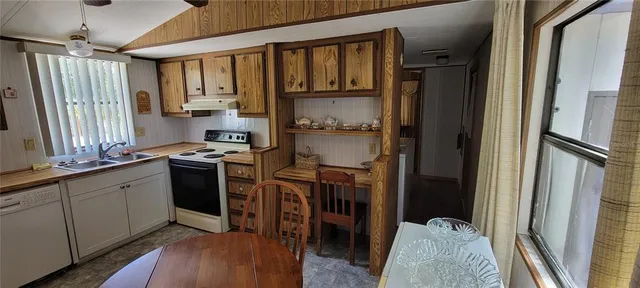 a kitchen with stainless steel appliances granite countertop a refrigerator stove and sink