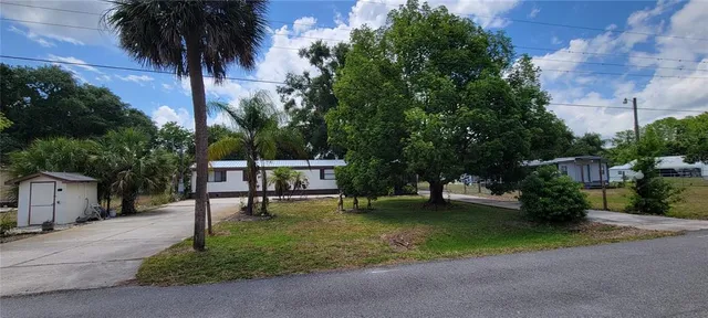 a swimming pool with outdoor seating and yard