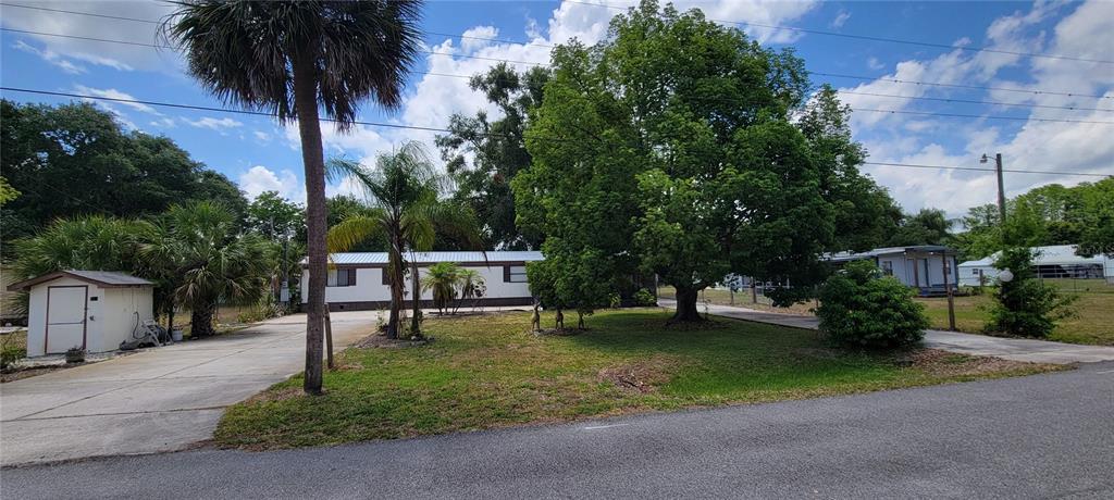 100 Pine Drive Kenansville, FL 34739 - Photo 2 of 34 a swimming pool with outdoor seating and yard