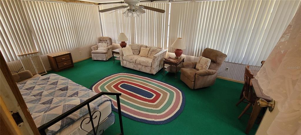 100 Pine Drive Kenansville, FL 34739 - Photo 23 of 34 a living room with furniture and a large window