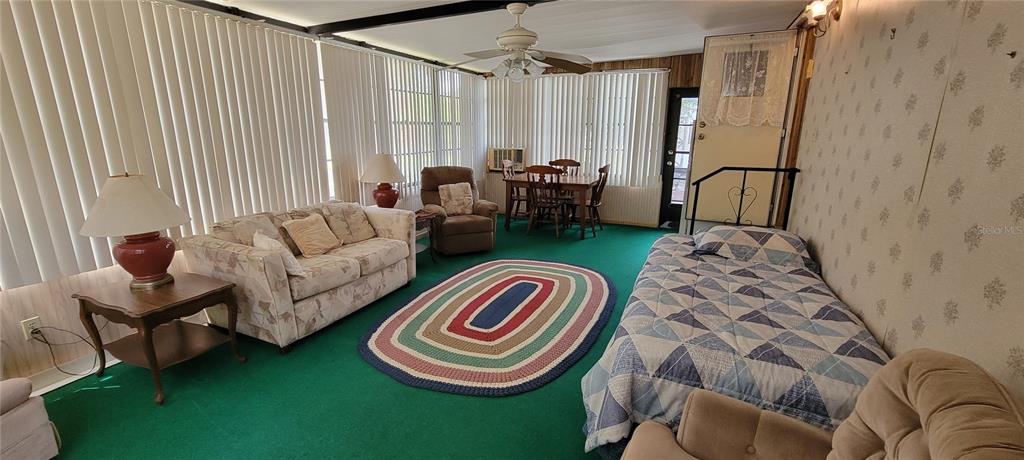 100 Pine Drive Kenansville, FL 34739 - Photo 25 of 34 a bedroom with bed and a chair