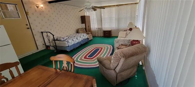 a view of a yard with a tree and a wooden bench