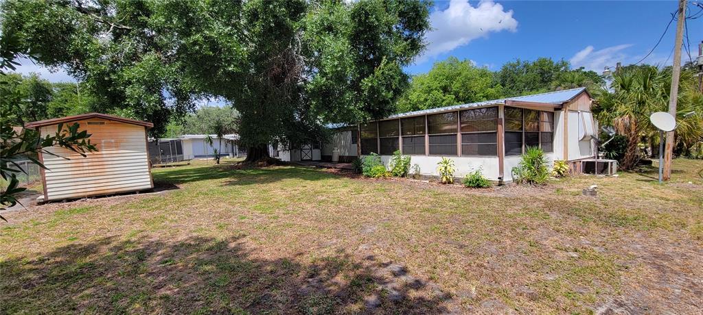 100 Pine Drive Kenansville, FL 34739 - Photo 29 of 34 a view of a backyard with a garden