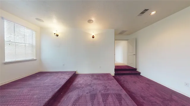 a view of a room with wooden floor and window