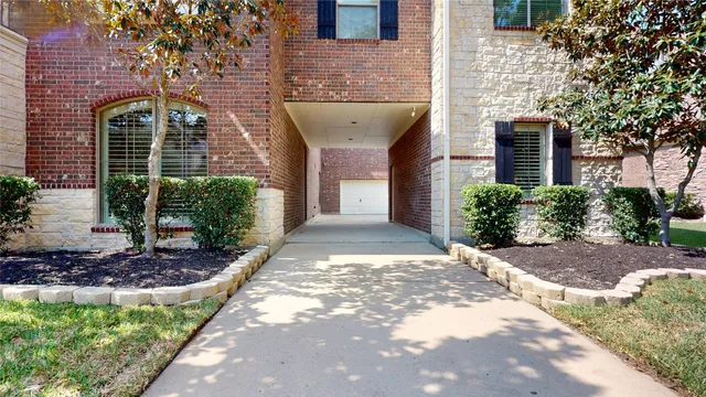 a view of a brick house with a yard