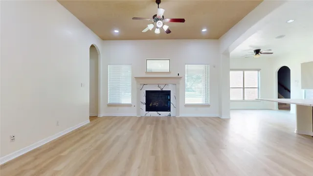 a view of a livingroom with wooden floor and a fireplace