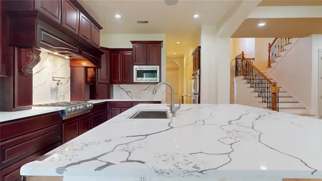 a kitchen with a sink a stove and a refrigerator