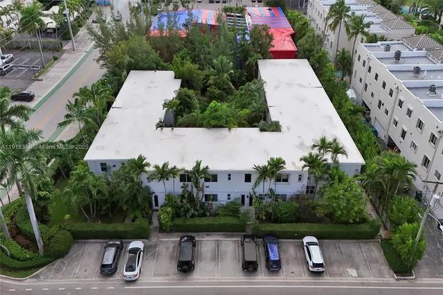 an aerial view of a house with pool garden and a yard