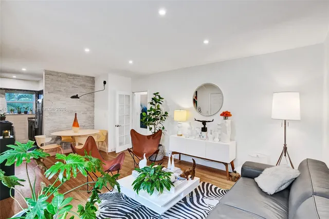 a dining room with furniture and wooden floor