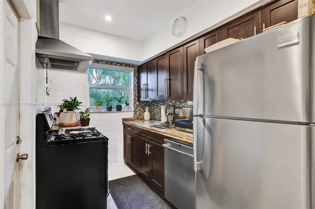 a kitchen with a stove and a refrigerator