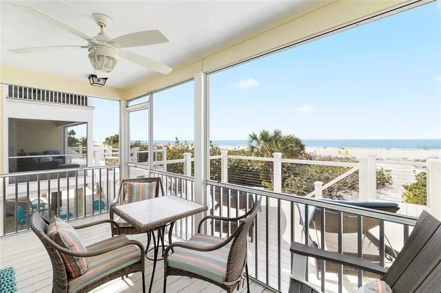 a view of roof deck with dining table and chairs