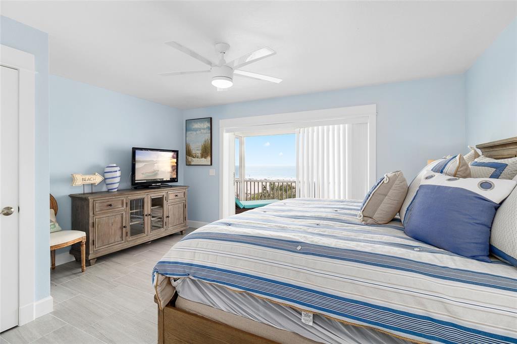 460-5 Gulf Boulevard, Unit 4 Boca Grande, FL 33921 - Photo 16 of 26 a bedroom with a bed and a flat screen tv