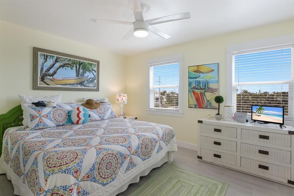 460-5 Gulf Boulevard, Unit 4 Boca Grande, FL 33921 - Photo 22 of 26 a bedroom with a bed and a window