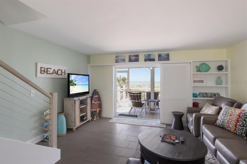 460-5 Gulf Boulevard, Unit 4 Boca Grande, FL 33921 - Photo 24 of 26 a living room with furniture and a flat screen tv