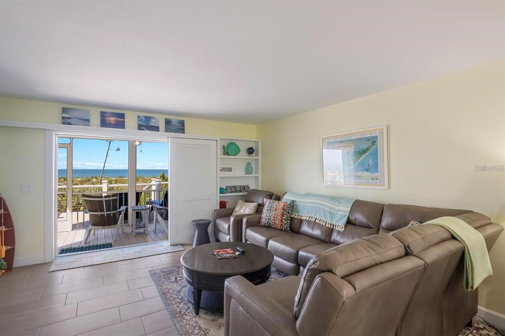 460-5 Gulf Boulevard, Unit 4 Boca Grande, FL 33921 - Photo 25 of 26 a living room with furniture and a floor to ceiling window