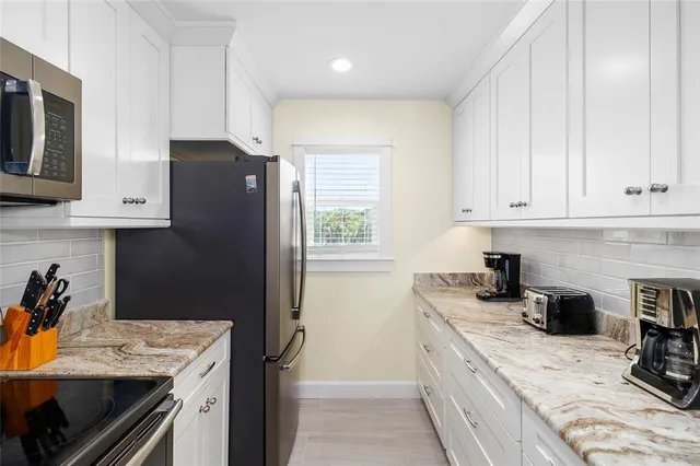 a kitchen with a stove a sink and a refrigerator