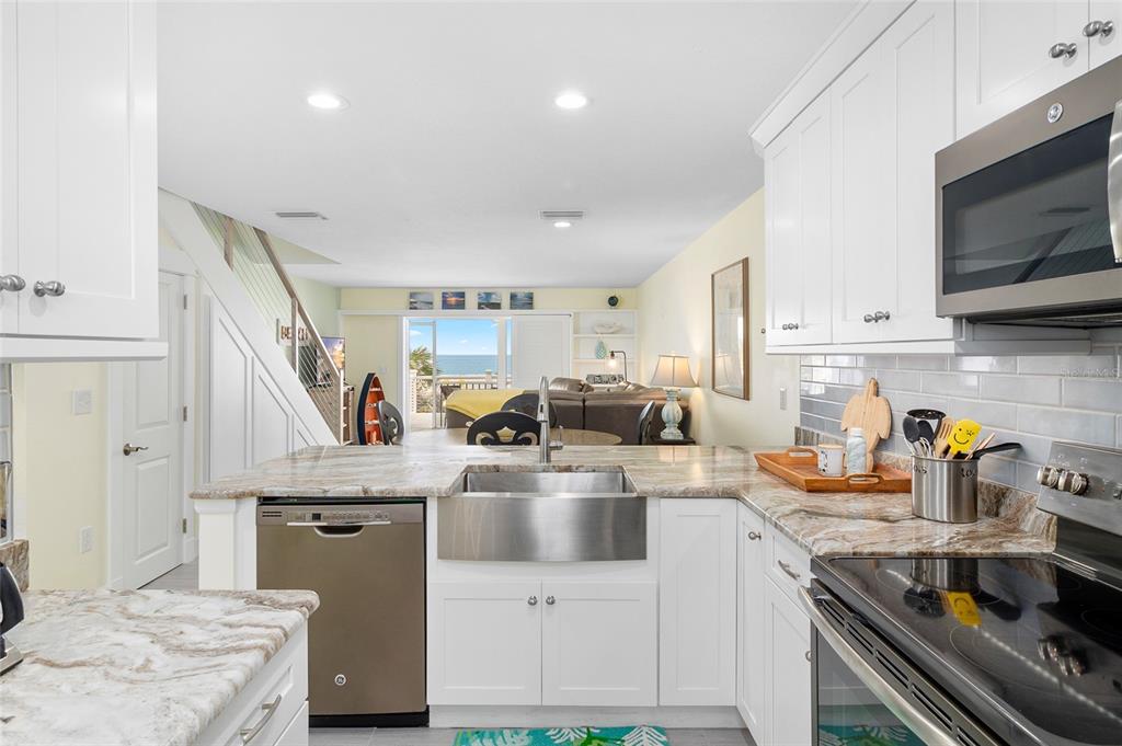 460-5 Gulf Boulevard, Unit 4 Boca Grande, FL 33921 - Photo 6 of 26 a kitchen with a stove a sink and a refrigerator