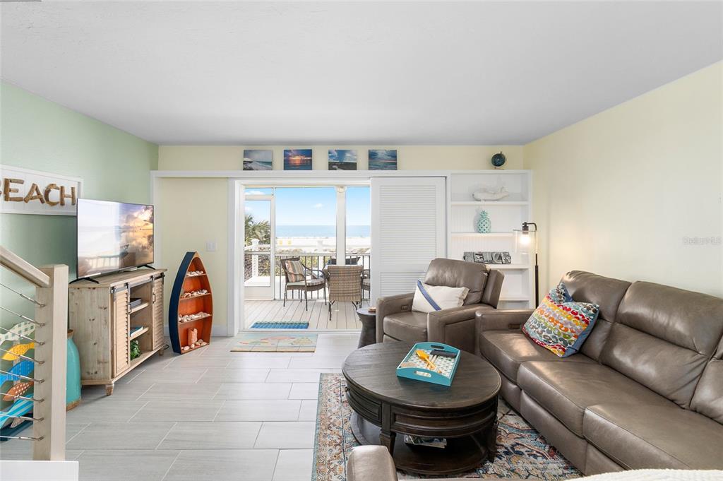 460-5 Gulf Boulevard, Unit 4 Boca Grande, FL 33921 - Photo 9 of 26 a living room with furniture a rug and a flat screen tv