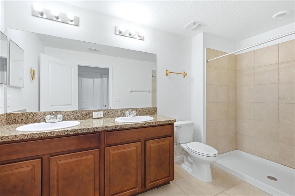 12909 Dream Catcher Way Riverview, FL 33579 - Photo 20 of 32 a bathroom with a granite countertop sink toilet and mirror