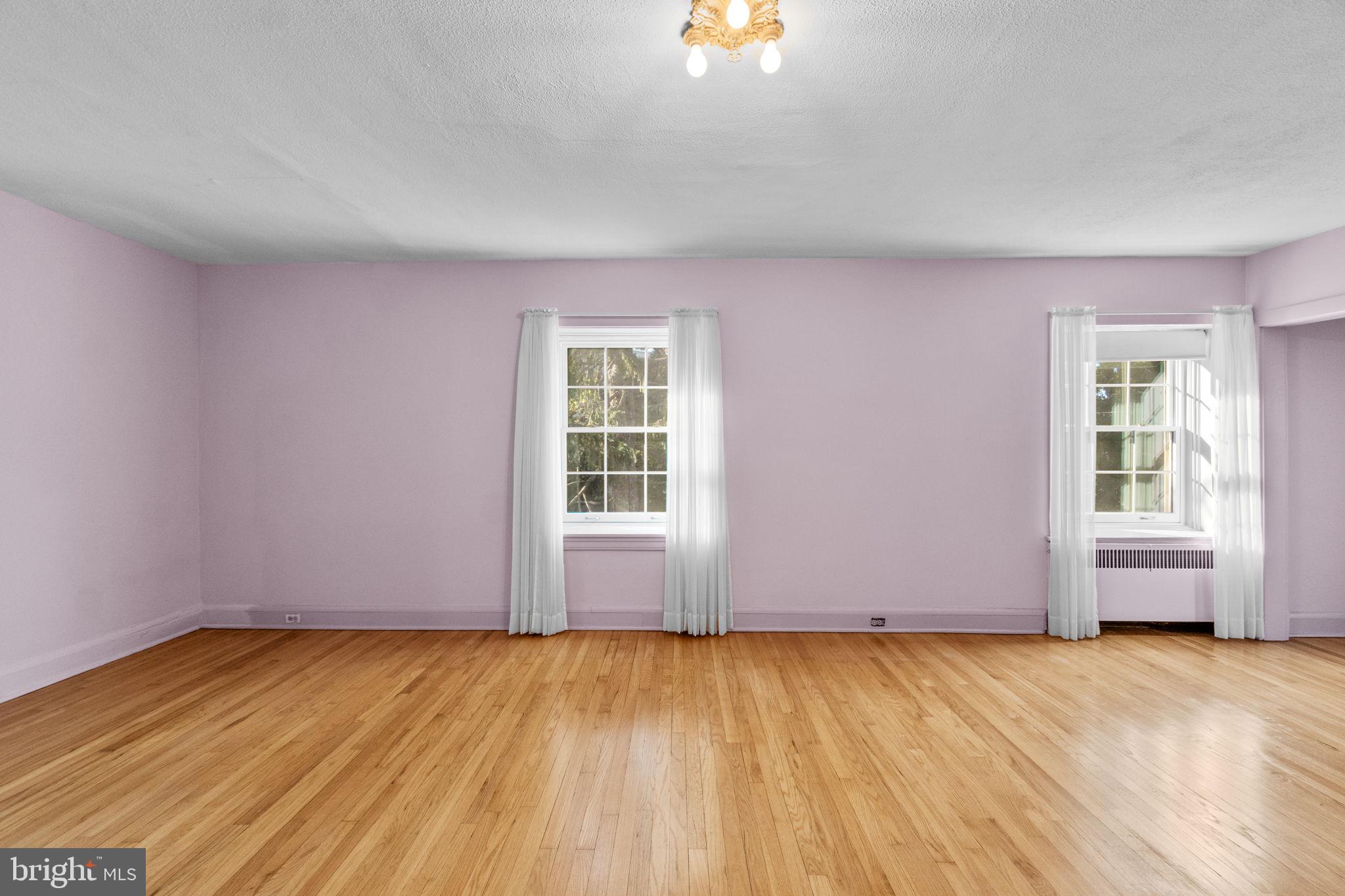 3 Center Road Baltimore, MD 21286 - Photo 13 of 57 an empty room with a wooden floor and windows