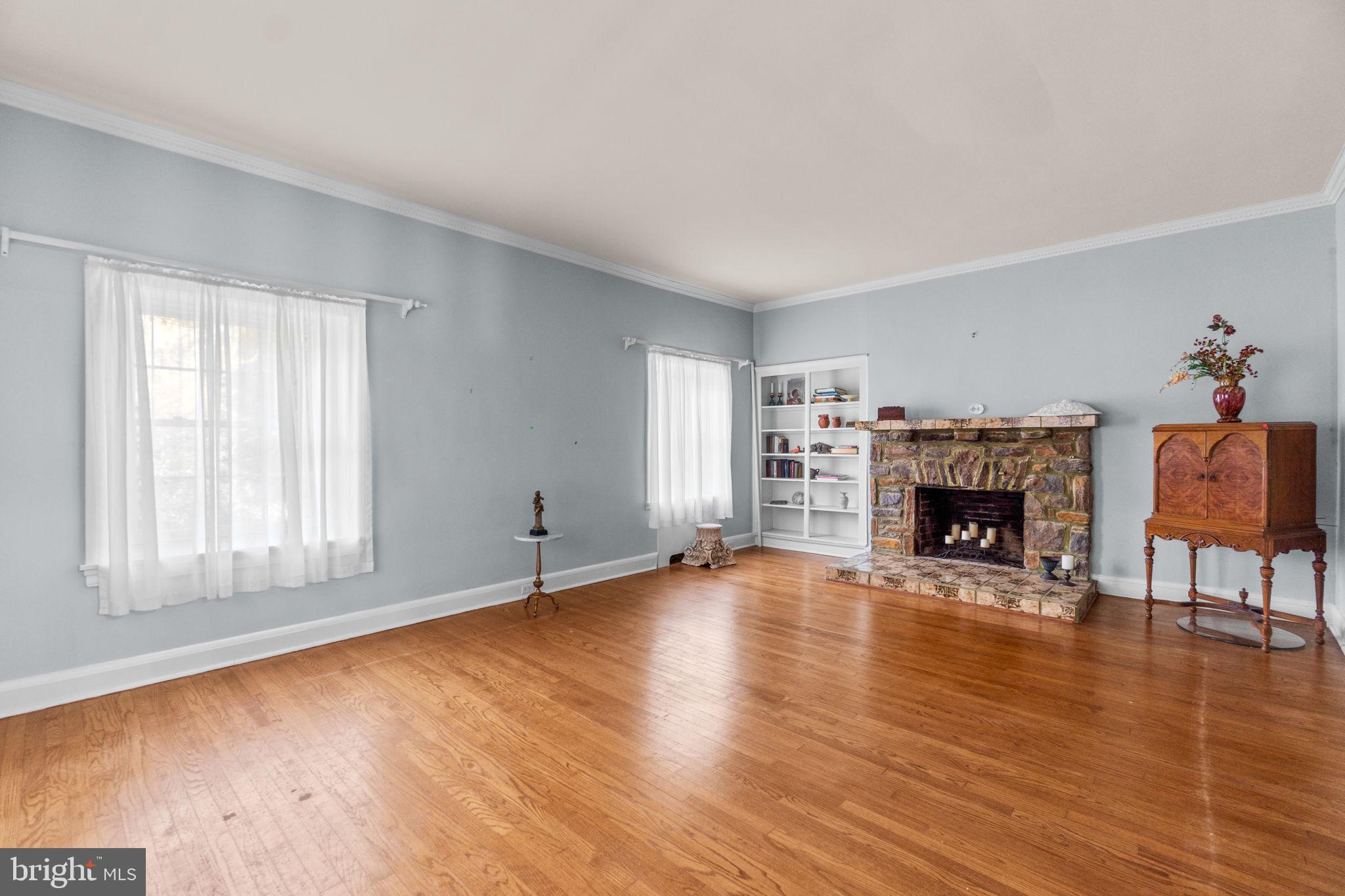 3 Center Road Baltimore, MD 21286 - Photo 15 of 57 an empty room with fireplace and wooden floor