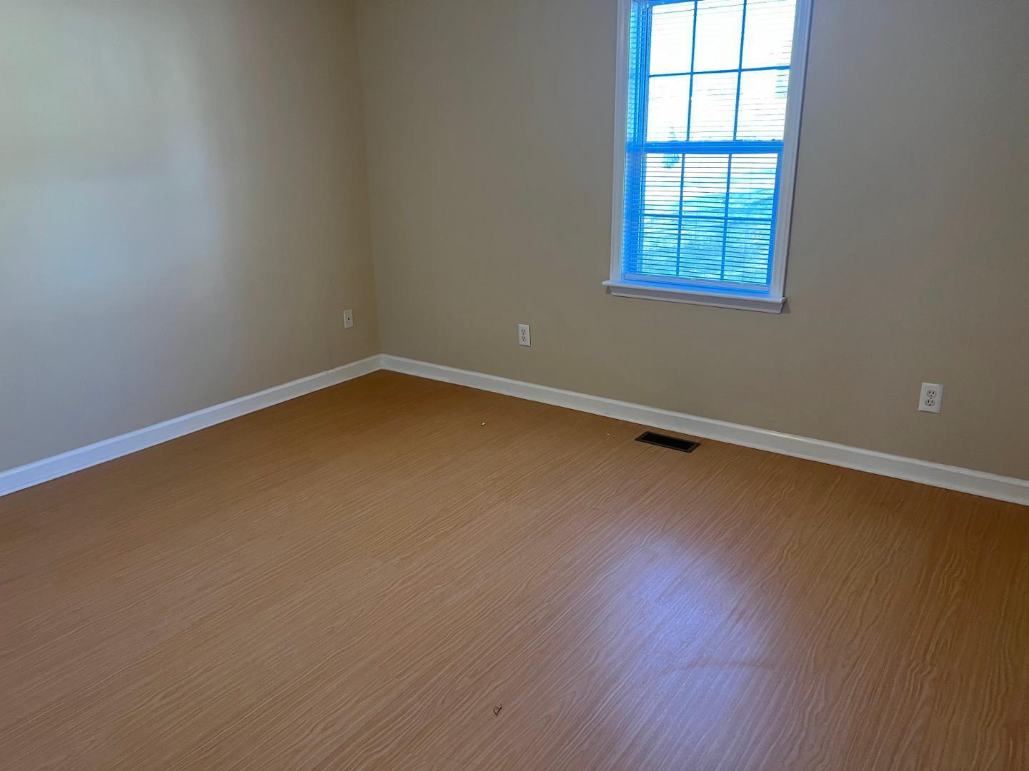 106 Bald Drive Clayton, NC 27520 - Photo 18 of 37 an empty room with wooden floor and windows