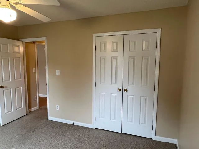 a kitchen with granite countertop a sink stove and microwave