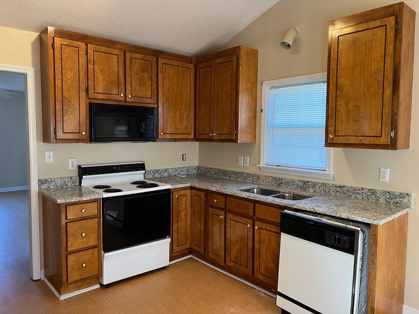 106 Bald Drive Clayton, NC 27520 - Photo 21 of 37 a kitchen with granite countertop a sink stove and microwave