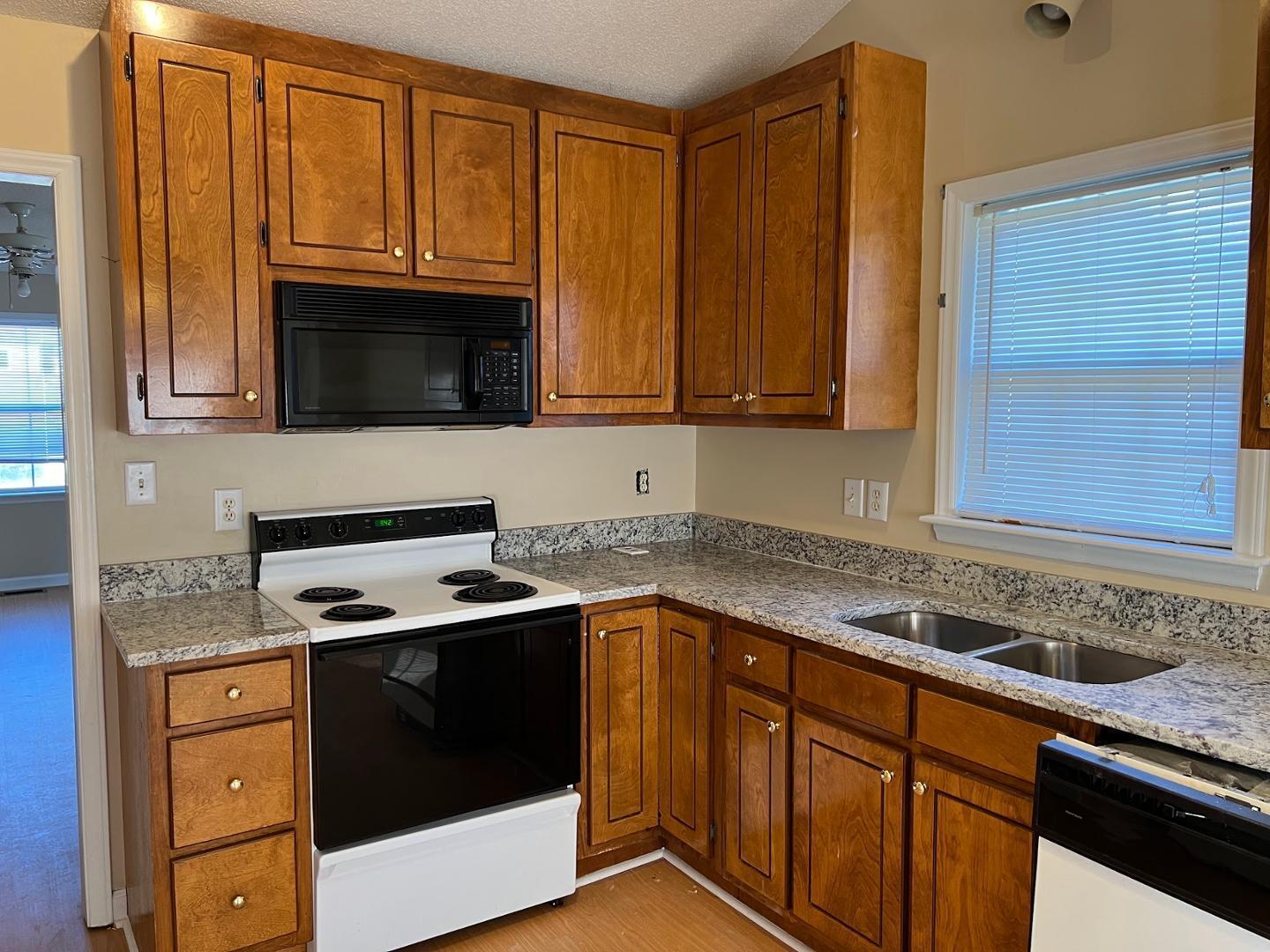 106 Bald Drive Clayton, NC 27520 - Photo 23 of 37 a kitchen with granite countertop a sink stove and microwave