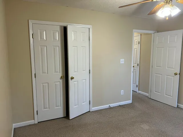 a bathroom with a granite countertop sink a toilet and shower