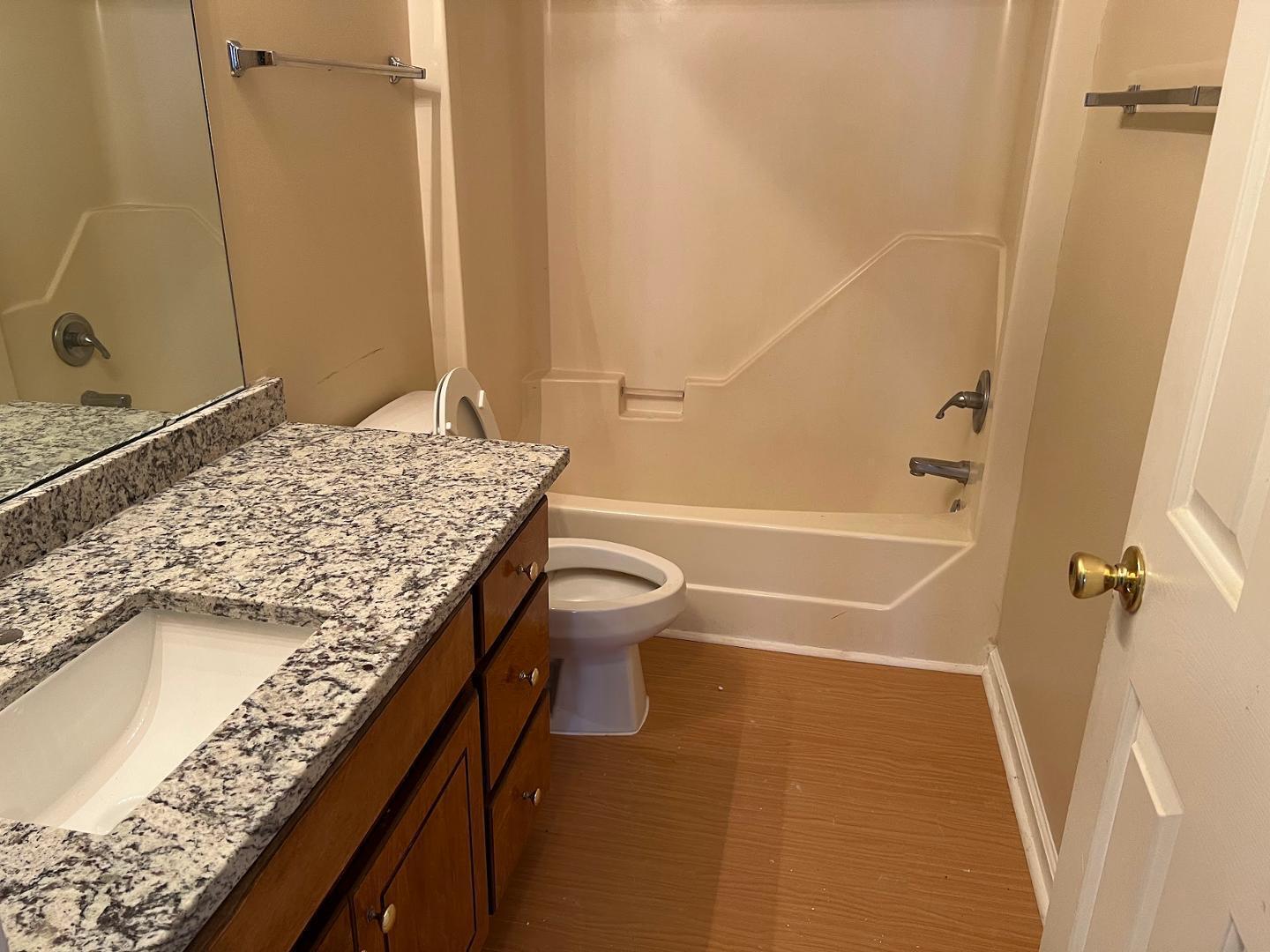 106 Bald Drive Clayton, NC 27520 - Photo 33 of 37 a bathroom with a granite countertop sink a toilet and shower