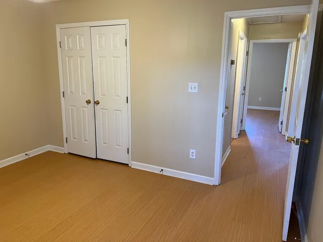 a view of a room with wooden floor