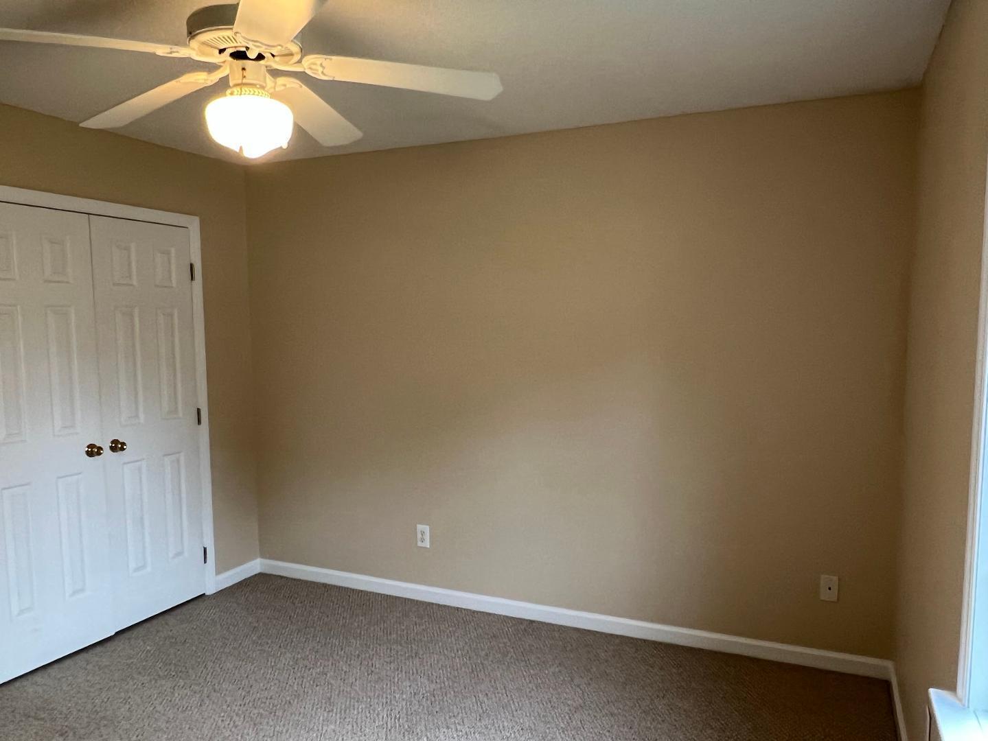 106 Bald Drive Clayton, NC 27520 - Photo 8 of 37 an empty room with a chandelier fan and closet area