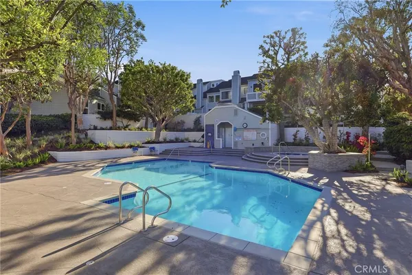 a view of a house with pool and sitting area