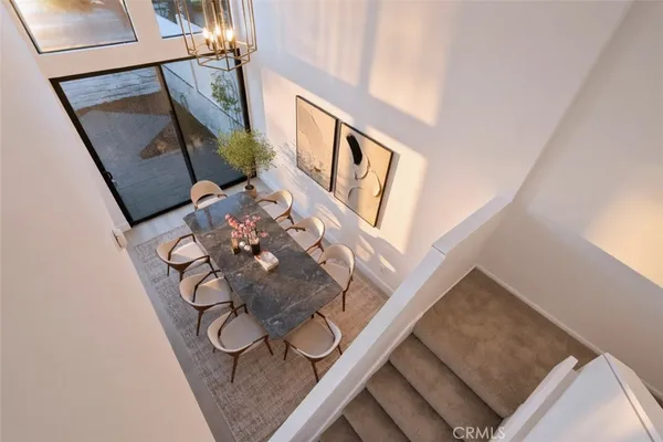 a kitchen with stainless steel appliances a stove a microwave and white cabinets