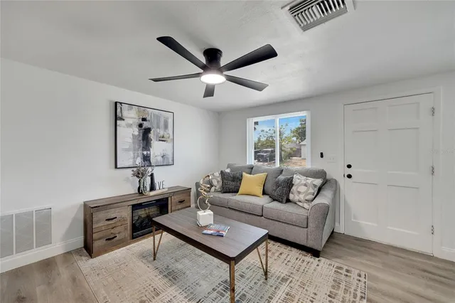 a living room with furniture and a potted plant