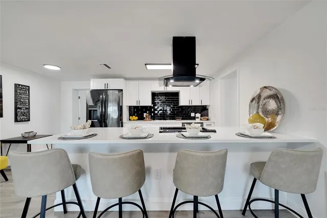 a kitchen with a sink a stove and cabinets