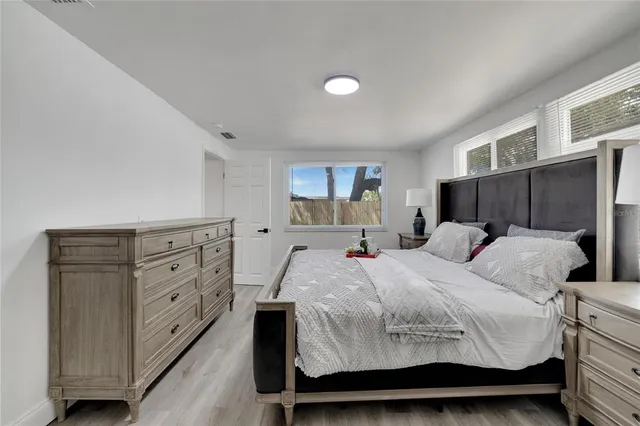 a very nice looking room with a wooden floor and a toilet