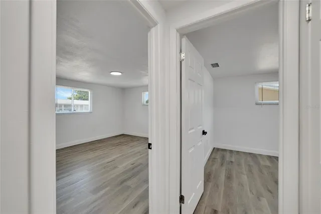 an aerial view of residential houses with outdoor space and trees