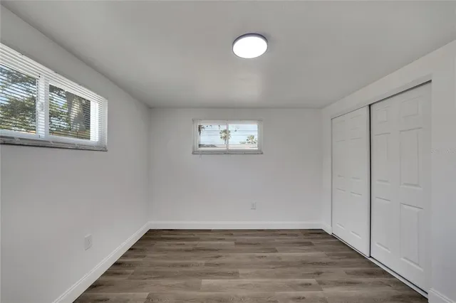 an aerial view of residential houses with outdoor space and trees