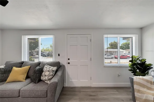 a living room with furniture and view of kitchen
