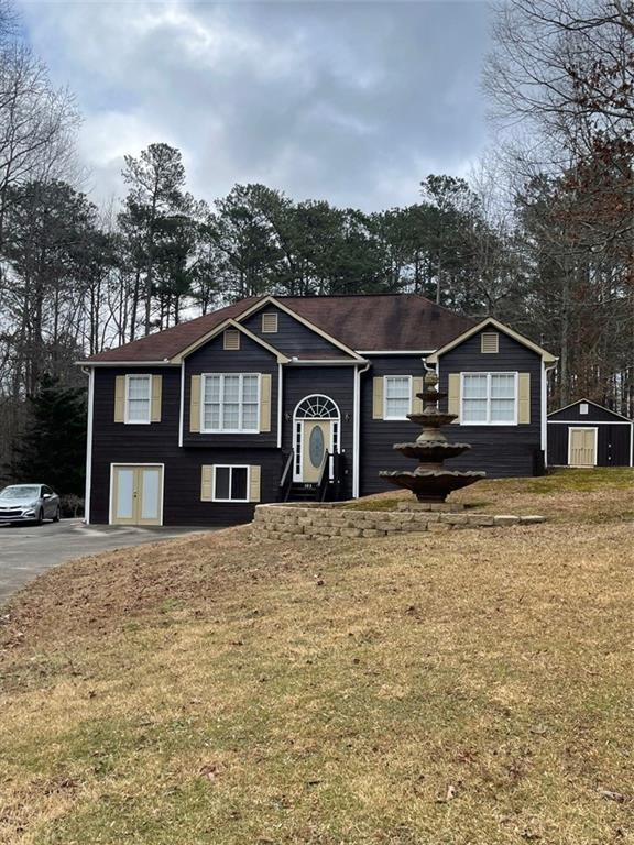 103 Live Oak Court Dallas, GA 30157 - Photo 1 of 25 a front view of a house with a yard covered in snow