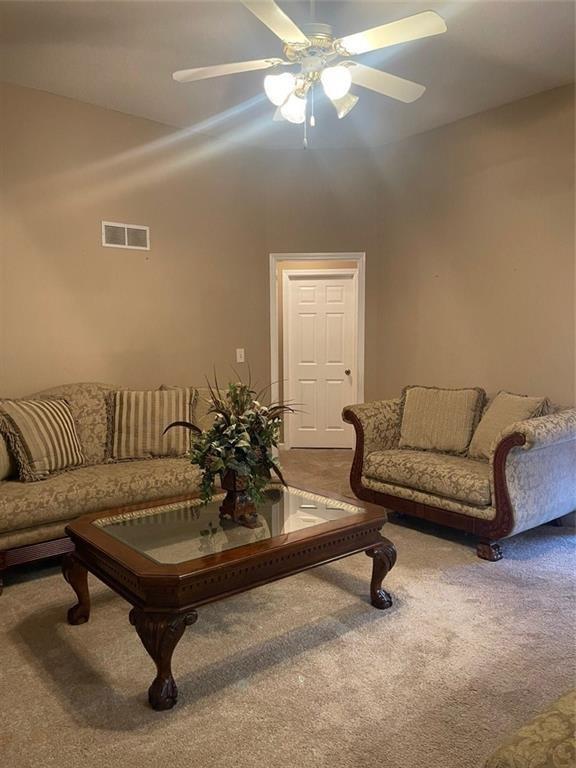 103 Live Oak Court Dallas, GA 30157 - Photo 23 of 25 a living room with furniture and a chandelier