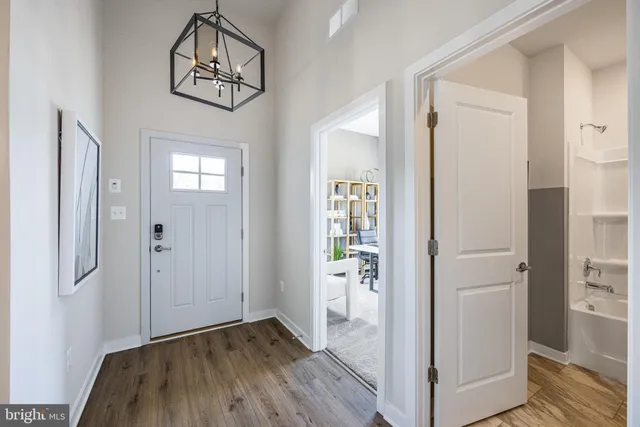 a view of a hallway with wooden floor and closet area