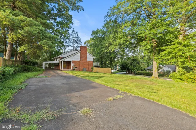 a front view of house with yard and trees