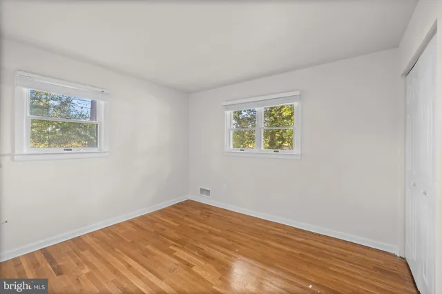 a view of room with window and wooden floor