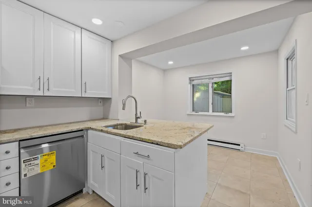 a kitchen with a sink cabinets and window