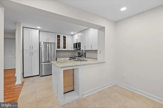 a kitchen with stainless steel appliances cabinets a sink and a counter top space