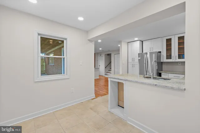 a large kitchen with kitchen island a sink stainless steel appliances and cabinets